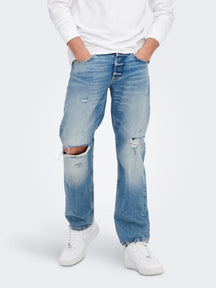 Jeans scaoilte imeall - denim gorm éadrom